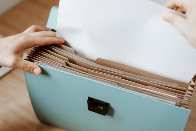 person pulling paper from a folder