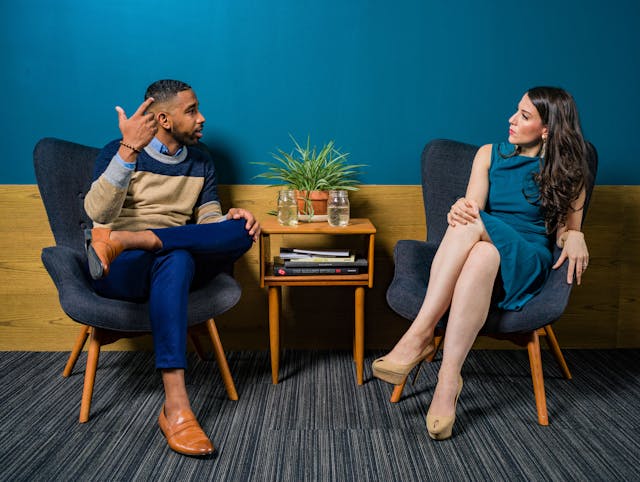 two-people-sitting-down-in-business-causal-cloths-having-a-discussion